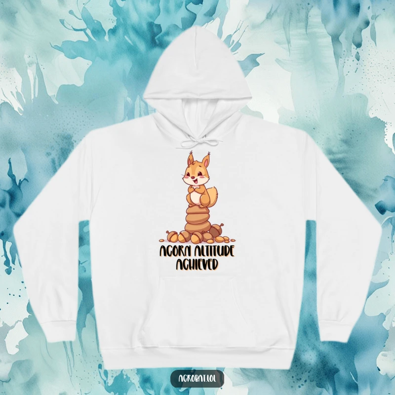 Funny hoodie with a curious squirrel looking delighted while balancing on a tall stack of acorns, celebrating nature's triumphs.